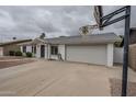 Charming single-story home with a well-maintained front yard and an attached two-car garage at 12228 S Pewaukee St, Phoenix, AZ 85044