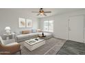 Bright living room featuring stylish furniture, neutral colors, and lots of natural light at 12228 S Pewaukee St, Phoenix, AZ 85044