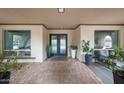 Stylish front entrance with double doors, potted plants, and brick-paved patio at 1444 E Myrna Ln, Tempe, AZ 85284