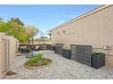 Enclosed patio with pavers, a circular garden, a seating area, and decorative planters at 1444 E Myrna Ln, Tempe, AZ 85284