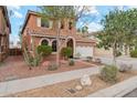 Inviting two-story home with manicured landscaping, rock features, and a cozy exterior aesthetic at 14744 W Poinsettia Dr, Surprise, AZ 85379
