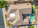Desert home featuring a large tile roof, central courtyard fountain, and backyard pool at 14841 S 6Th Pl, Phoenix, AZ 85048