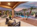 Relaxing covered back patio, complete with a pristine pool and mountain views at 14841 S 6Th Pl, Phoenix, AZ 85048