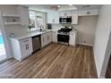 Bright kitchen featuring modern white cabinets, stainless steel appliances, and new countertops at 1545 W Marco Polo Rd, Phoenix, AZ 85027