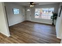 Cozy living room featuring wood-look flooring, a large window, and a front door with a window at 1545 W Marco Polo Rd, Phoenix, AZ 85027