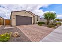 Charming single-story home featuring a brick driveway, two-car garage, and desert landscaping in front yard at 16139 S 178Th Dr, Goodyear, AZ 85338