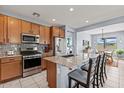 Modern kitchen with stainless steel appliances, granite countertops, a spacious island and barstool seating at 16139 S 178Th Dr, Goodyear, AZ 85338