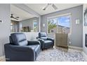 Inviting living room featuring two comfortable chairs, neutral paint, and abundant natural light from a large window at 16139 S 178Th Dr, Goodyear, AZ 85338