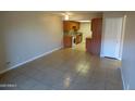 Open living room with tile flooring and kitchen view at 16602 N 25Th St # 129, Phoenix, AZ 85032