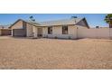 Single-story home with rock yard and neutral color scheme under a clear sky at 17040 N 39Th Ave, Glendale, AZ 85308