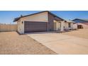 Single-story home featuring a gravel yard, gray garage door, and modern architecture under a clear sky at 17040 N 39Th Ave, Glendale, AZ 85308