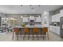 Modern kitchen boasting a large island with bar seating, stainless steel appliances, and ample cabinet space at 1915 N Bernard Cir, Mesa, AZ 85207