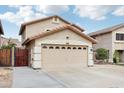 Well-maintained two-car garage with desert landscaping and a gated side yard at 2306 E Parkside Ln, Phoenix, AZ 85024