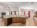Open-concept kitchen with ample countertop space and view of the breakfast nook and Gathering room at 25564 W Ripple Rd, Buckeye, AZ 85326
