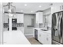 Newly renovated kitchen with white cabinets, stainless steel appliances and a large island at 3046 E Glenrosa Ave, Phoenix, AZ 85016