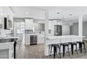 Open-concept kitchen and living space with kitchen island, bar seating and stainless steel appliances at 3046 E Glenrosa Ave, Phoenix, AZ 85016