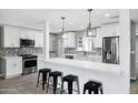 Modern kitchen featuring white cabinetry, stainless steel appliances, and a quartz island at 3046 E Glenrosa Ave, Phoenix, AZ 85016