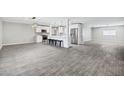 Open-concept living room with new flooring, kitchen island and stainless steel appliances at 3046 E Glenrosa Ave, Phoenix, AZ 85016