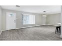 Open-concept living room, with new flooring, big window and access to kitchen at 3046 E Glenrosa Ave, Phoenix, AZ 85016