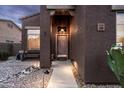 Inviting front entryway with warm lighting and a cozy bench, creating a welcoming first impression at 3488 N Lady Lake Ln, Casa Grande, AZ 85122