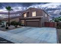 A well-kept two-story home with a wide driveway and desert landscaping offers suburban charm at 3488 N Lady Lake Ln, Casa Grande, AZ 85122