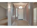Welcoming foyer with neutral tile flooring, arched doorways, and transom window above the front door at 4017 W Irma Ln, Glendale, AZ 85308