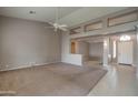Open concept living room featuring high ceilings, neutral paint, tile flooring, and decorative architectural details at 4017 W Irma Ln, Glendale, AZ 85308