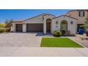 Charming home with a neat lawn area, a two car garage, and a delightful garden area at 4467 S 116Th Ln, Avondale, AZ 85323