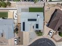 Overhead view of a well maintained home with solar panels, manicured lawn, and desert landscaping at 4632 E Kachina Trl, Phoenix, AZ 85044