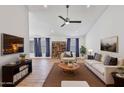 Bright living room with vaulted ceilings, fan, wood floors, and neutral decor at 4632 E Kachina Trl, Phoenix, AZ 85044