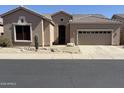 Desert-landscaped Southwest-style home, featuring a two-car garage and covered entry at 4944 E Villa Theresa Dr, Scottsdale, AZ 85254