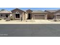 Southwest-style home featuring desert landscaping and a two-car garage at 4944 E Villa Theresa Dr, Scottsdale, AZ 85254