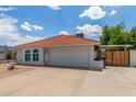 Well-maintained house with a red tile roof, two-car garage and low-maintenance desert landscaping at 4953 W Acoma Dr, Glendale, AZ 85306