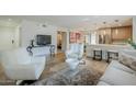 Open-concept living area with hardwood floors, a modern kitchen, and comfortable seating arrangements at 5201 N 24Th St # 107, Phoenix, AZ 85016