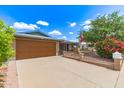 Brick house featuring a well-maintained front yard with an attached two-car garage at 5210 W Ironwood Dr, Glendale, AZ 85302