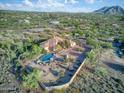 Panoramic aerial view of desert home showcasing a pool, native landscaping and mountain views in the background at 6524 E Rockaway Hills Dr, Cave Creek, AZ 85331