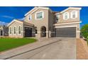 Attractive home boasting a three-car garage, green lawn, and a circular driveway at 6621 S Balboa Dr, Gilbert, AZ 85298