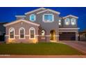 Charming home featuring a three-car garage, a well-kept lawn, and an arched entryway at 6621 S Balboa Dr, Gilbert, AZ 85298