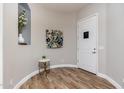 Inviting foyer featuring wood floors, a decorative niche, and a modern accent table at 6621 S Balboa Dr, Gilbert, AZ 85298