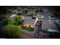 An aerial shot captures a home with a covered patio, landscaped backyard, and neighborhood surroundings at 6623 S Classic Way, Gilbert, AZ 85298
