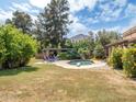The backyard features a sparkling swimming pool with lounge chairs and a diving board at 6735 E San Juan Ave, Paradise Valley, AZ 85253