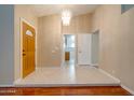 Open foyer with tiled floors and decorative lighting features a glimpse of the kitchen at 7402 W Corrine Dr, Peoria, AZ 85381