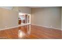 Open living room space with hardwood floors, high ceilings and view into the kitchen at 7402 W Corrine Dr, Peoria, AZ 85381