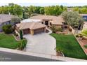 Sprawling home with a lush green lawn, mature trees, and a long driveway at 844 E County Down Dr, Chandler, AZ 85249