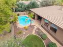 Aerial view of a backyard with a swimming pool and ample landscaping at 844 E County Down Dr, Chandler, AZ 85249