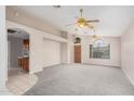 Bright living room with new carpet, vaulted ceilings and decorative ceiling fans at 1019 N Monterey St, Gilbert, AZ 85233