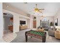 Bright living room features a foosball table, comfortable seating, and a neutral color palette, perfect for entertaining at 1019 N Monterey St, Gilbert, AZ 85233
