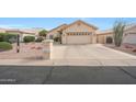 Charming single-story home with a two-car garage and well-maintained desert landscaping in front at 10613 E Nacoma Dr, Sun Lakes, AZ 85248