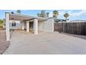 Spacious driveway and carport area, complemented by a partial view of the home's exterior at 10619 N 38Th Ave, Phoenix, AZ 85029
