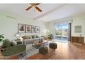 Cozy living room with stylish furniture, wood floors, and a sliding glass door to the backyard at 10619 N 38Th Ave, Phoenix, AZ 85029